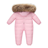 The Baby Wears White Eiderdown Over A Onesie And Down Jacket